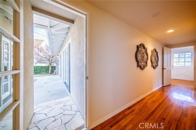 Main hallway with convenient door to the backyard and patio.