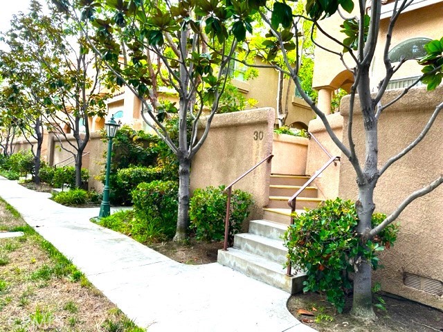 Grand and private entrance through the patio, this private end unit is surrounded by mature trees and lush lndscaping.