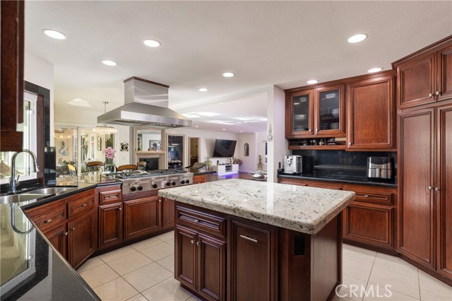 A gourmet kitchen and an eat-in dining space open to the comfortable family room and bar.