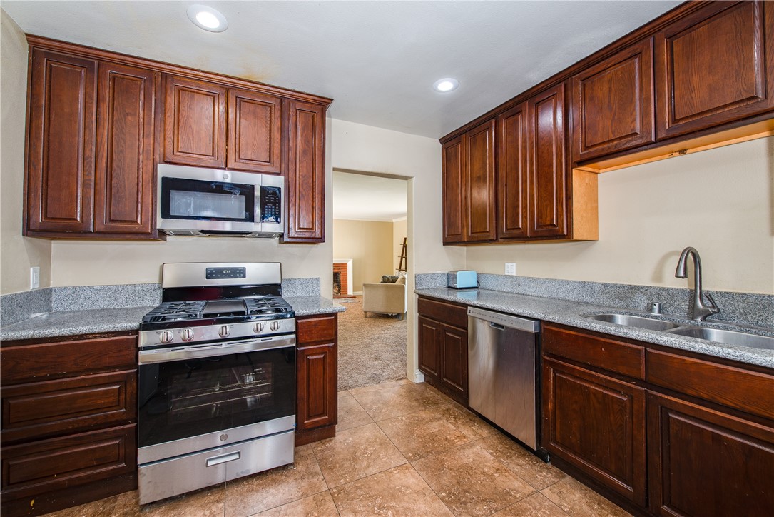 The granite countertops are highlighted by the large cabinets.