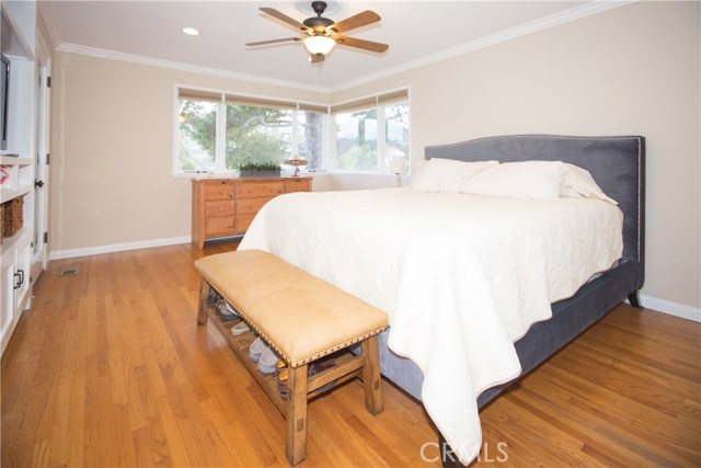 The main level Master Bedroom opens to the upstairs deck and overlooks beautiful views of green rolling hills.
