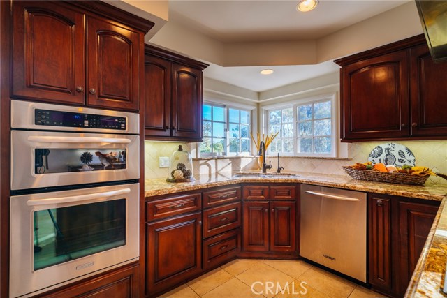 The beautiful kitchen features granite Counter tops, 5-burner Wolf range, stainless appliances, double convection oven and more.