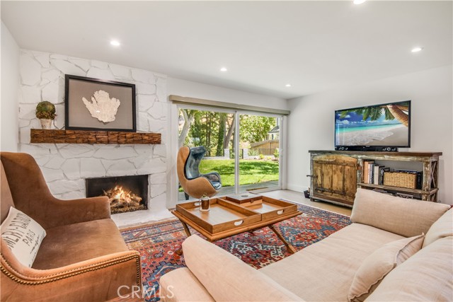 Family Room with fireplace & wet bar leads to the large peaceful backyard