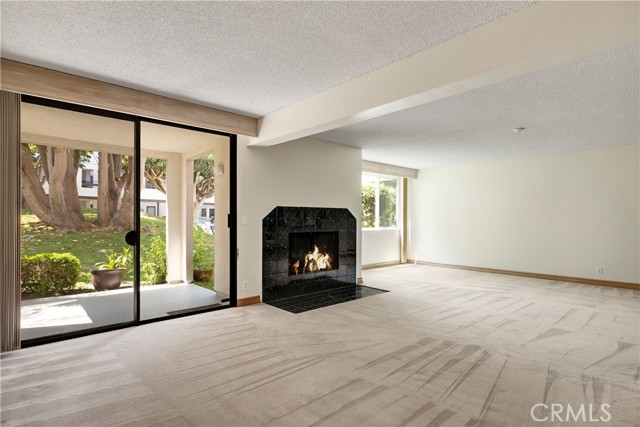 Main living area - with wood buring fireplace and views of the pool.