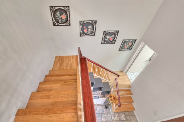 Upper View Of Stairway.  Door To Right Leads To Powder Room.