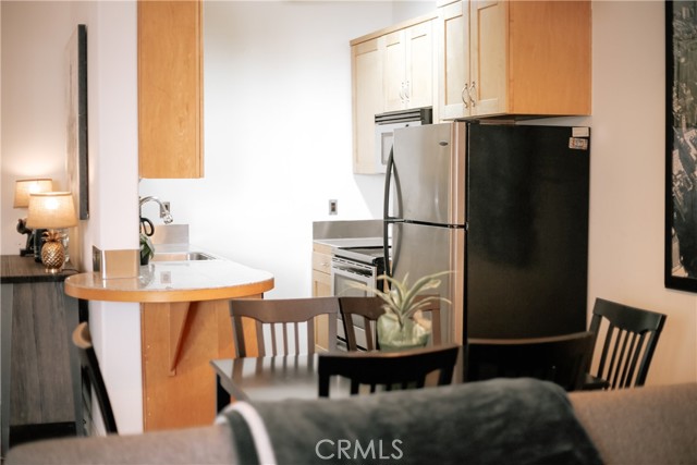 Dining area with kitchen in the background.