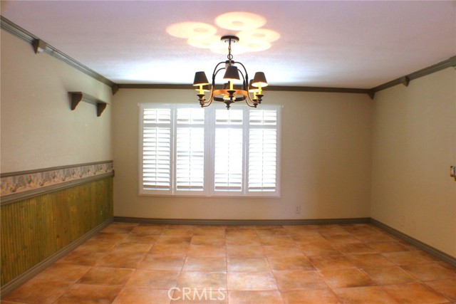 Terra Cotta Tile Floors and Plantation Shutters in the Dining Room at the front of the house.