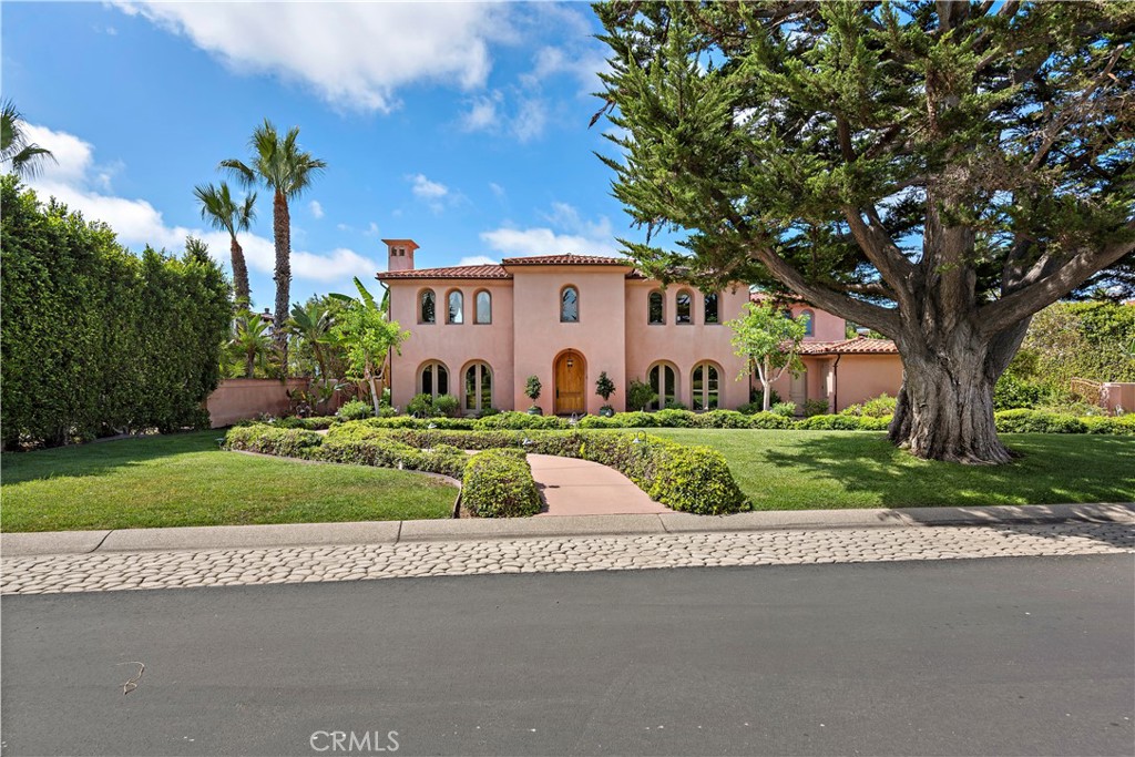 Step into the realm of grandeur with this custom villa nestled within the prestigious Cotton Point Estates, a gated oceanfront community in San Clemente. Situated on an expansive flat lot, this exquisite residence offers not one but two private beach access paths. Stroll to the renowned Trestles surf spot or opt for a secluded entrance to the beach north of Trestles. Embrace the coastal lifestyle by biking or walking to nearby attractions such as Califia State Park and Beach or the iconic surf spots at San Onofre. Crafted in 2003, this luxurious home exudes elegance and quality craftsmanship at every turn. From the arched windows and French doors to the Enkeboll Honduran mahogany millwork and crystal chandeliers, every detail speaks of sophistication. Step through the impressive foyer with its circular staircase adorned with custom leaf-motif railings, and discover over 7,100 square feet of living space. The main level features a formal living room with a soaring double-height ceiling, a cozy fireplace, a spacious formal dining room, and multiple family rooms for relaxation and entertainment. The chef-inspired kitchen boasts a large island, custom cabinetry, and top-of-the-line appliances. Two main-level bedrooms with ensuite bathrooms, both ADA compliant, offer convenience and accessibility. Upstairs, the primary suite is a sanctuary of luxury, complete with a sunny patio, oversized walk-in closet, steam shower, and jetted tub. Additional bedrooms open onto a balcony with ocean views, perfect for enjoying the coastal breeze. Outside, the sprawling grounds span nearly 29,000 square feet and feature lush landscaping, a large swimming pool, intimate patios, and verdant lawns. With its ideal southwest orientation, the home is bathed in sunlight throughout the day. A gated driveway leads to a three-car garage with ample storage space. Cotton Point Estates, home to just 15 residences, including the historic La Casa Pacifica, offers exclusive beach access and a private enclave atmosphere. Conveniently located near top private schools such as St. Margaret's Episcopal School and J. Serra High School, as well as various amenities, this villa epitomizes luxurious coastal living at its finest. Take advantage of the opportunity to make this extraordinary property your own.