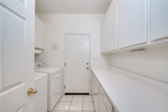 The laundry room has tile floors, lots of cabinets and included washer and dryer. Gas and electric dryer hook-ups.