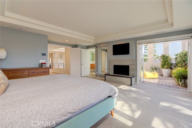 Primary Bedroom with fireplace opens to Private Deck