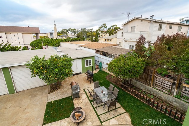 View of the backyard of the 5,203 square foot lot showing the two garages and the, similar in size, work shop.