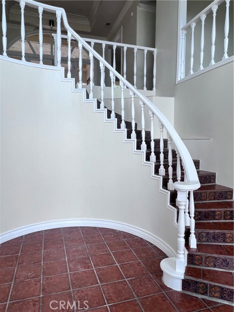 Double door entry to a foyer and a semi circular stairway to start your day.