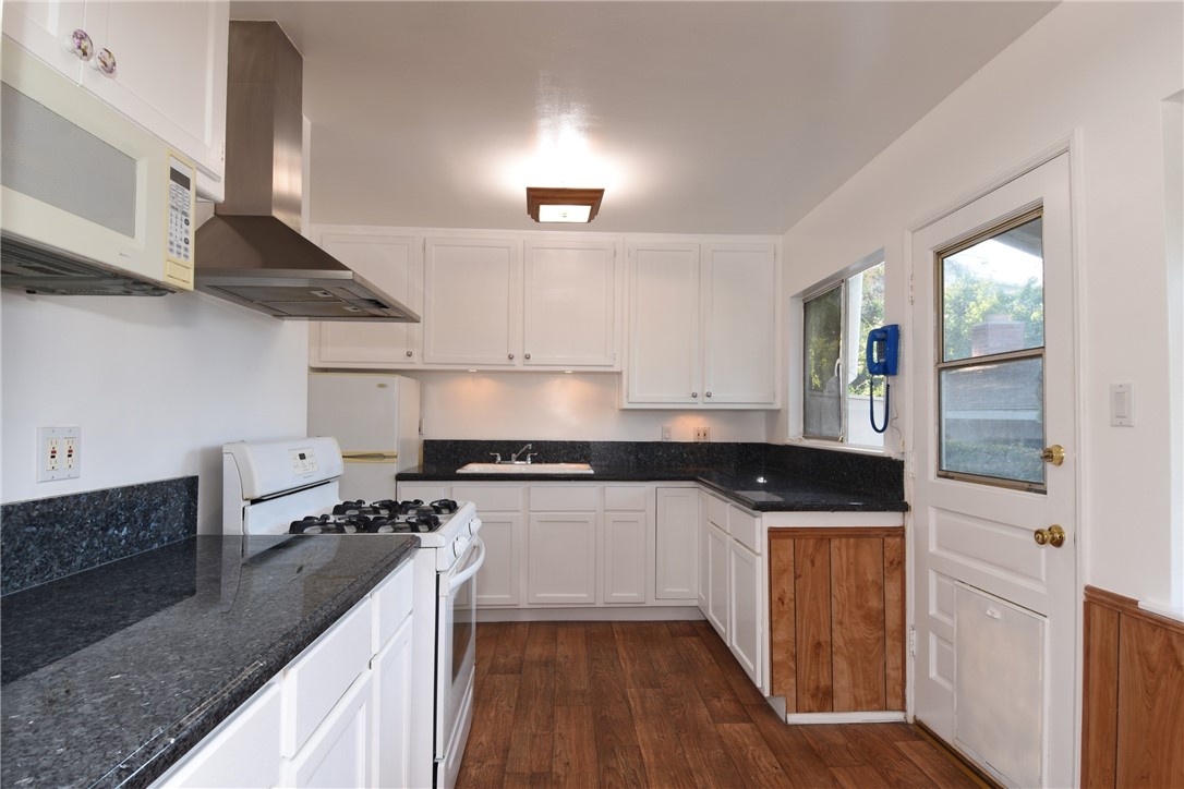 Nice updated kitchen has freshly painted cabinets, granite counter tops, and nice stainless hood!