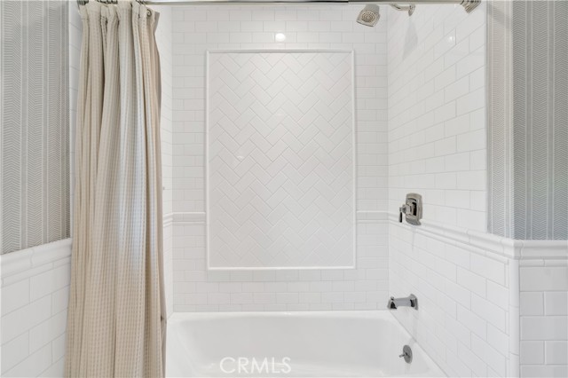 Second bathroom bathtub/shower with white tile