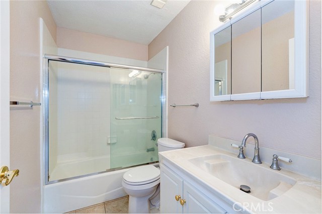 updated with tile flooring, new paint, mirror vanity and light fixture...