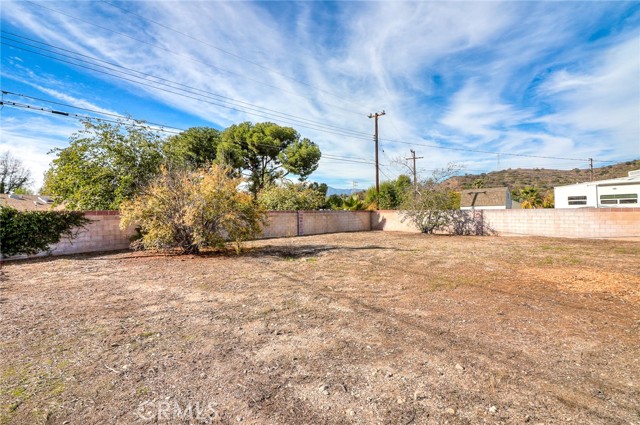 Large backyard with block walls.