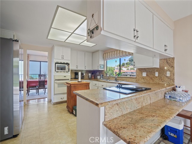The kitchen flows to the dining room and offers views of the canyon ... The kitchen flows to the dining room and offers views of the canyon ...