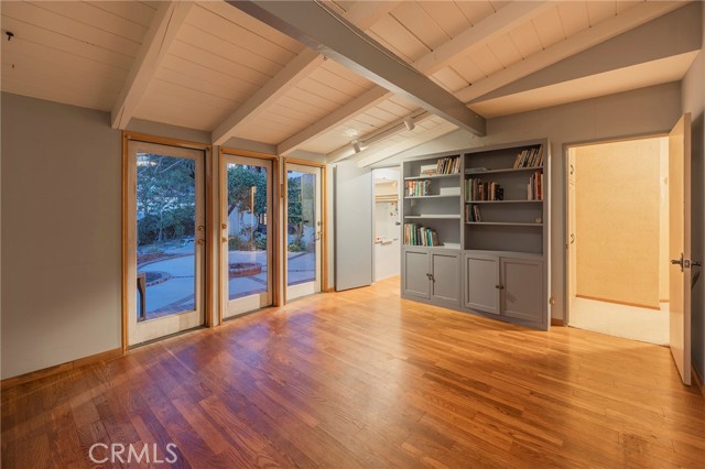 Second bedroom with doors to the backyard and a walk in closet