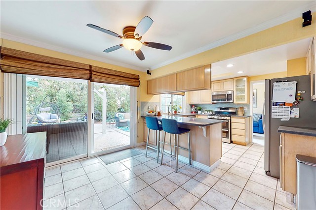 Second optional dining area with ceiling fan and glass sliding doors leading to the backyard.