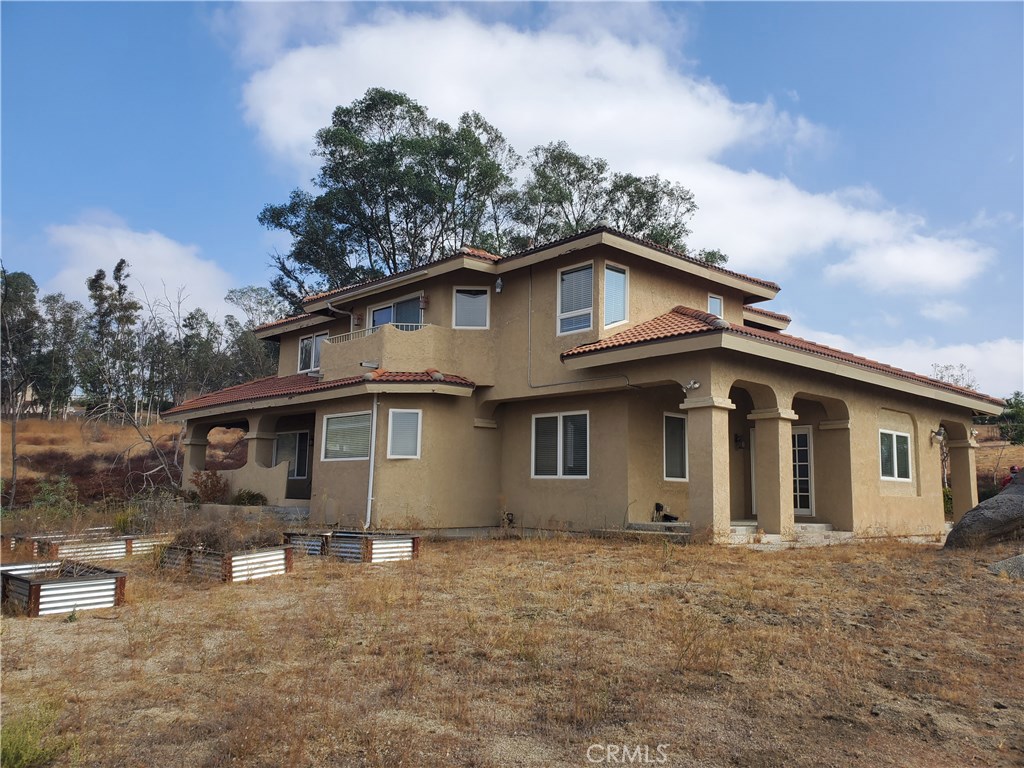 38630 Mesa Road Temecula, California TEMECULA WINE COUNTRY ESTATE HOME w/8.08 acres. 3287 sq foot, 4 bedroom, 3 bathroom, 3 car garage. Possible lot split. Zoned Residential/Agricultural-2.5 acre minimum. This is a builder/investor dream project. It has decks and balconies all around the property to enjoy the views!! Kitchen features maple cabinets, granite counters, island w/sink and electric cooktop, Viking appliances, Subzero refrigerator, slate & travertine flooring & walk-in pantry. There are formal dining & living rooms with wood flooring. The large family room has a beautiful stone-faced fireplace & a wet bar. The wrought iron staircase leads to the bedrooms. The large master suite has its own private balcony to enjoy the breathtaking sunsets and the hot air balloons. Master bedroom with romantic jetted tub, separate shower, dual sinks and a walk in closet. 2 bedrooms share a Jack & Jill bathroom, the 4th bedroom has a private access to the large back balcony. This property is equestrian friendly. Bring your RV, toys, you will have room for what ever you want...