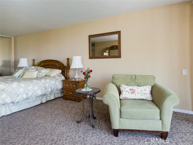 Huge master bedroom has sitting area with views of ocean
