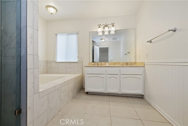 Primary bathroom with dual sinks, tub and separate shower.
