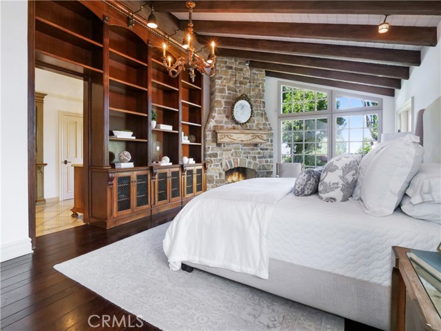 custom floor to ceiling bookcase in the master suite and fireplace are definitely the focal point