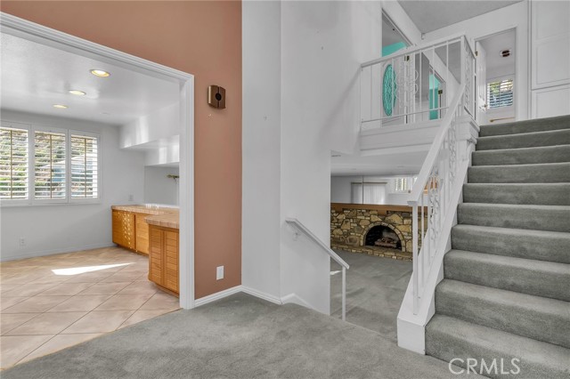 Entrance to Kitchen, view of 1st level fire place and steps to two bedrooms