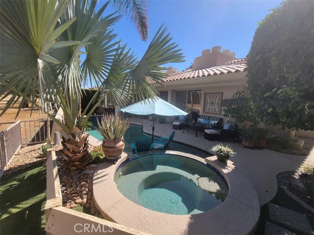 Look no further, this beautiful two-story 3 bedroom, 3 1/4 bath home has it all. Upgraded tile floor, stacked-stone fireplace, wet bar with huge windows overlooking greenspace and yard. Salt water private pool with sundeck ledge and spa, desert landscape, a primary suite with a huge oversized closet, tankless water heater, and even an elevator. And don't be concerned about that air conditioning bill, the home has solar panels - it's a must see! Third bedroom is currently being used as a den/office. Includes 24-hour guarded gate. Conveniently located by Eisenhower Medical Center, shopping and restaurants. Don't miss this opportunity to own a home in Rancho Mirage Country Club.