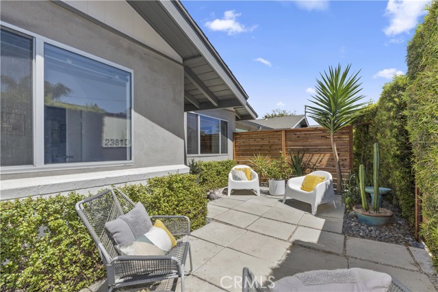 Front patio is enclosed with lush landscaping.