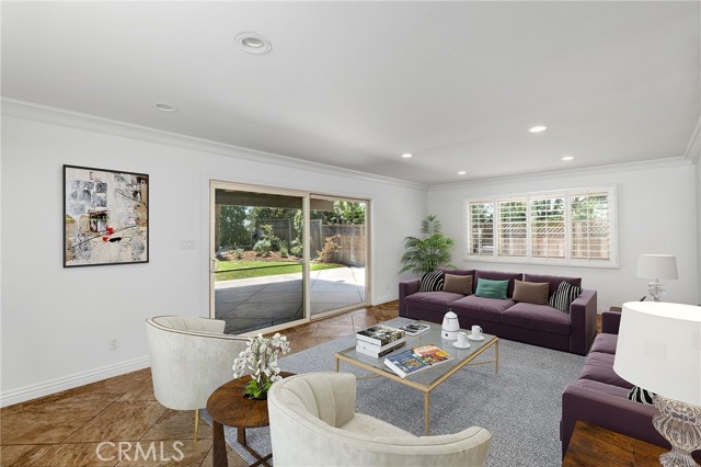 Downstairs entertaining room leads directly to the backyard. Photo has been virtually staged.