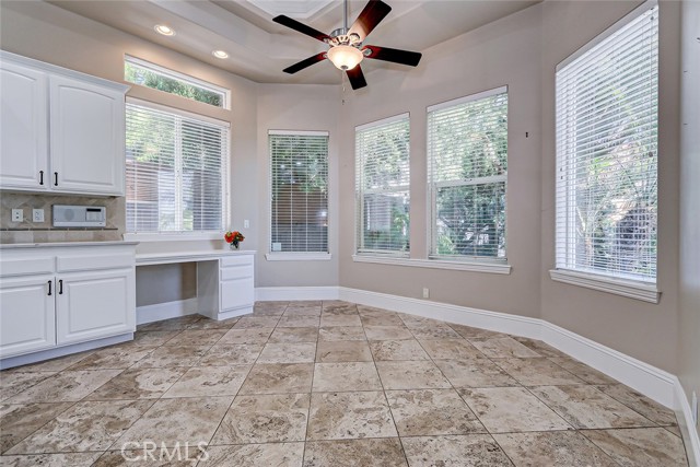 Command center in the heart of the kitchen with a built in desk adjacent to the breakfast nook.