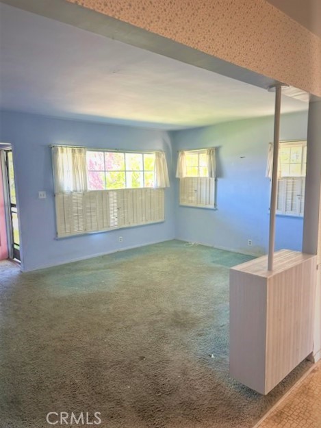 The Living Room Has Bright Windows Letting in Lots o fLight