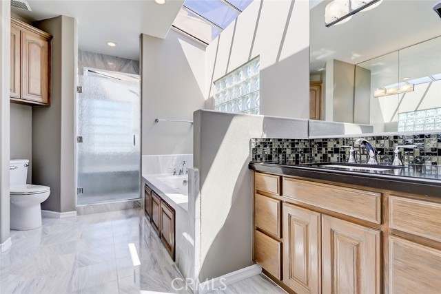 Light floods the primary bath through the skylights