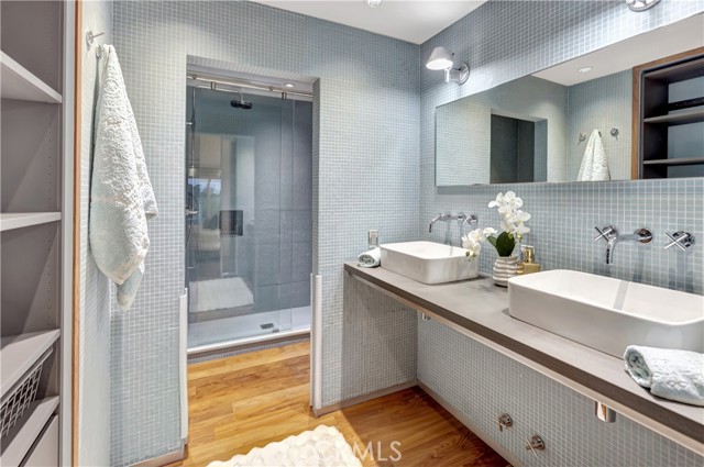 Master bath with walk-in shower and built in drawers and storage