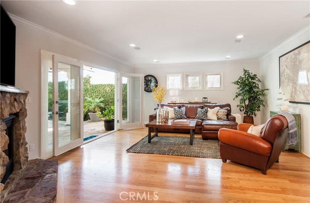 Family room featuring hardwood floors and a fireplace, French doors leading to the backyard