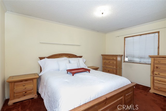 Main bedroom with glass mirror closet doors.