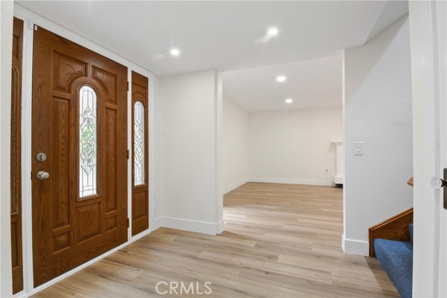 Welcoming entry with newer laminate flooring.