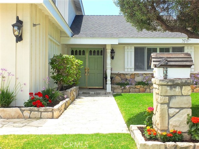 A stone pathway and matching stone flower beds great your guests as they walk up to this home A stone pathway and matching stone flower beds great your guests as they walk up to this home