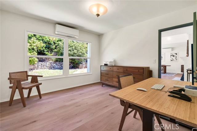 bedroom facing backyard, split AC unit and access to living room