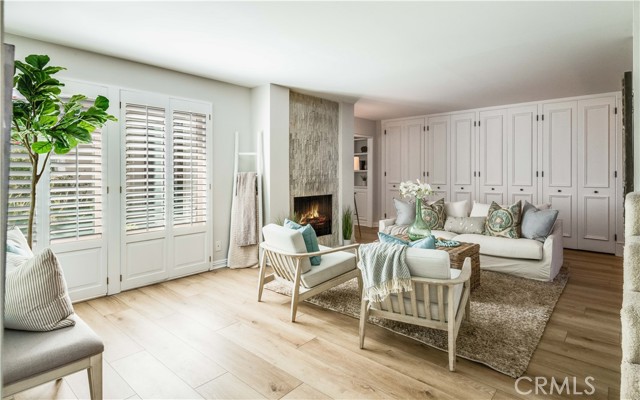 Living room with new luxury vinyl wide wood plank flooring and wall of built-in storage cabinets Living room with new luxury vinyl wide wood plank flooring and wall of built-in storage cabinets