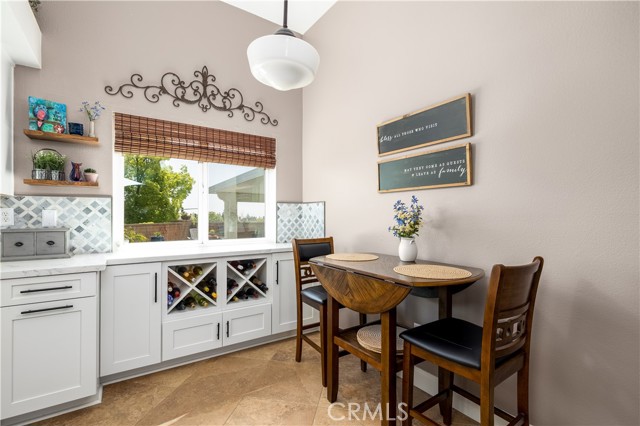 Kitchen is bright and sunny and has small eating area.