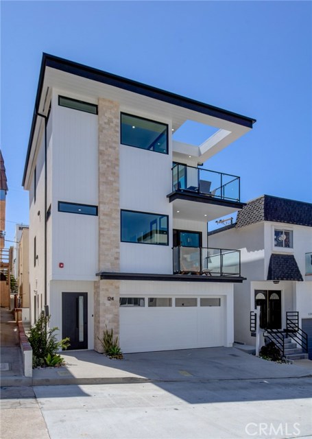 124 39th Street Manhattan Beach, California Stunning brand new ocean view single family on sensational wide street in El Porto. Steps to the beach and bike path, from this designer perfect custom residence. Two private balconies from family room and private master suite to gaze across the Pacific Ocean looking towards Malibu and of course Hawaii!!! High end finishes throughout with huge kitchen island and stainless steel Thermador kitchen appliances plus refrigerator finished with herring bone oak to match entry floors. Gorgeous oak floors throughout with stone wall in living room to capture the most discriminating tastes! Enter from the garage or front door on ground level with one spacious bedroom and an ensuite bath. Second level has the spacious master suite with the aforementioned balcony, secondary bedroom on this level too, with it's own bath. Large kitchen island for friends and family to gather or while watching the gorgeous sunsets out of the huge west facing windows.