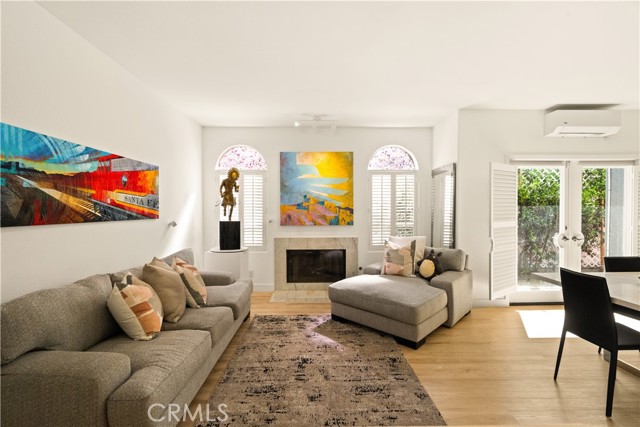 Formal step-down living room — fireplace, natural light, open to dining room