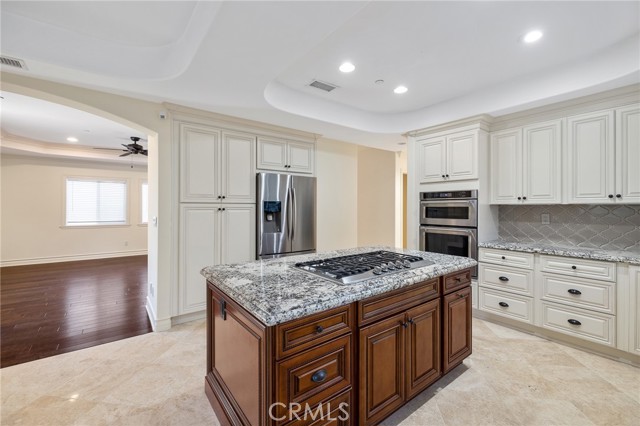 Custom kitchen with cooktop center island, granite counters