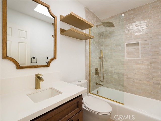 Guest bathroom with gorgeous finishes and skylight