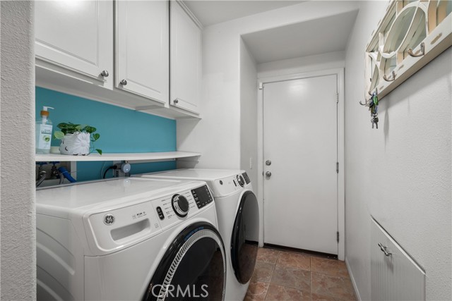 Laundry room with direct garage access and built in hamper