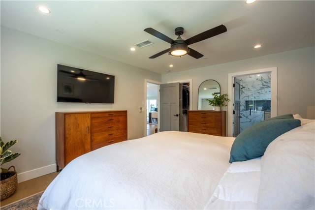 Main bedroom with view of bathroom and walk in closet