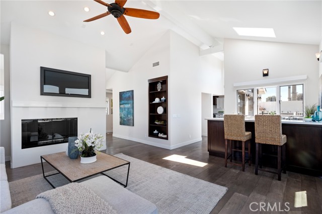 Living room, fireplace and bar with extra tall ceiling.