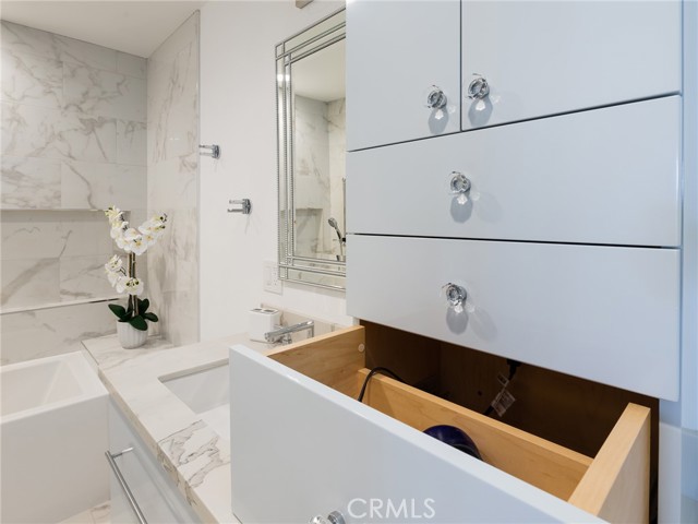 Convenient outlet within drawer to plug in hair dryer in primary bathroom.